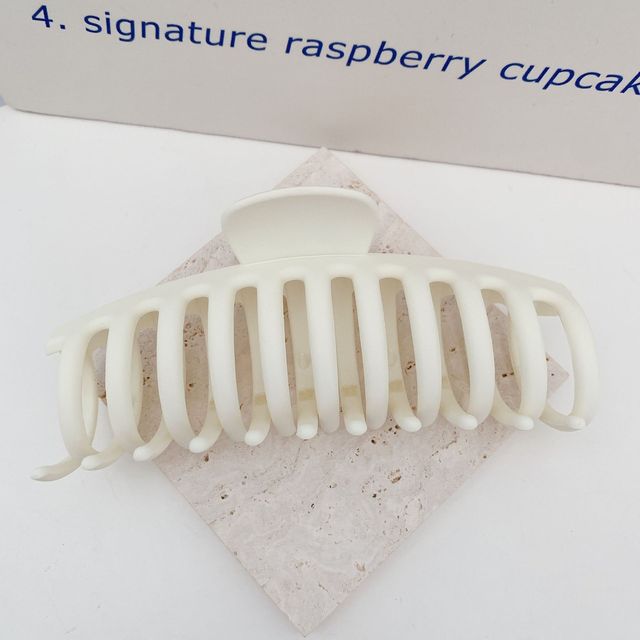 Classic white jumbo acrylic hair claw clip.