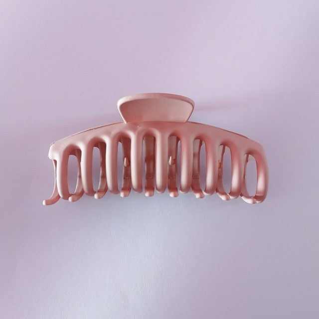 Jumbo hair claw clip in a playful pastel pink hue.