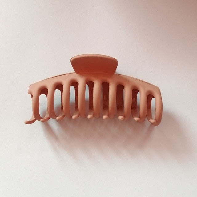 "A retro-inspired jumbo hair claw clip in orange.