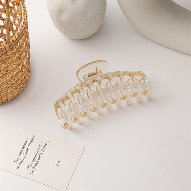 Shiny gold and clear jumbo hair claw clip for a touch of luxury.