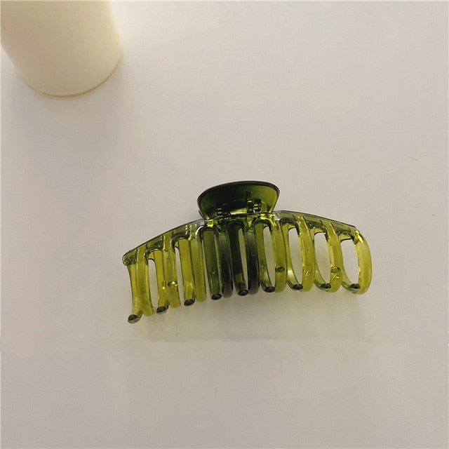 Jumbo hair claw clip featuring a mesmerizing galaxy green print.