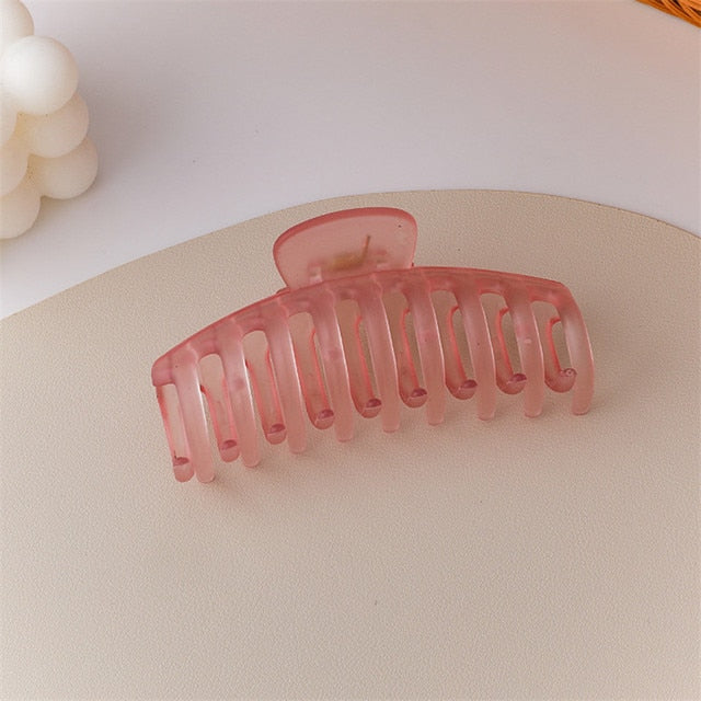 "Holographic jumbo acrylic hair claw clip for a futuristic look.